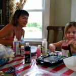 Clio paints with Gail from Our Space, which does art projects with kids with cancer. Click to visit their website.